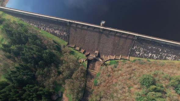 Aerial view looking down over Scar house reservoir landmark tilting up to Yorkshire countryside rura