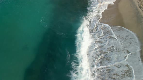 Waves Crash on a White Sandy Beach