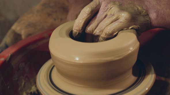 Close View of Manly Male Hands Making Clay Bowl, Using Wheel in Workshop