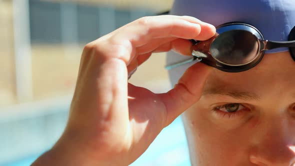 Male swimmer standing near pool side 4k