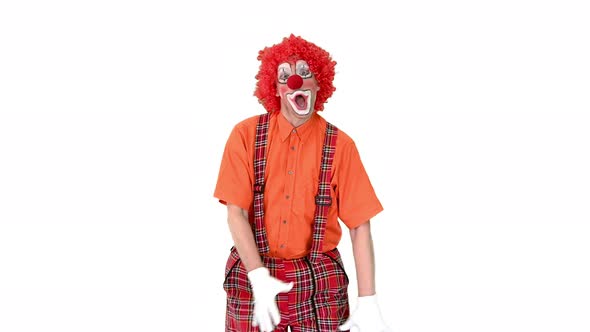 Clown Walking in a Comic Way Towards the Camera on White Background