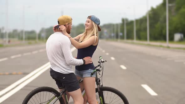 Young Couple Cycling in Town. Slow Motion