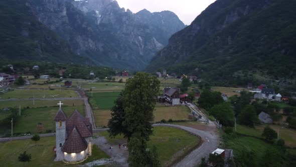 Flying Near Old Wooden Church and Trees in Thethi Valley Albania