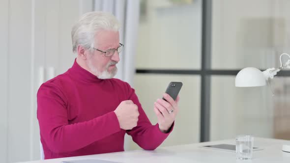 Old Man Reacting to Loss on Smartphone