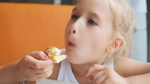 Beautiful Young Girl Eating Chicken in the Cafe