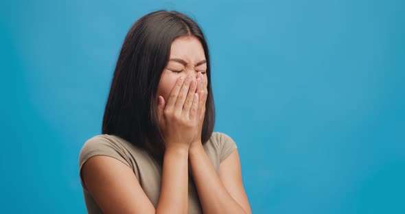 Cough Attack. Studio Shot of Young Asian Woman Coughing Over Blue Background, Free Space