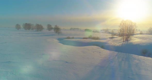 Aerial View of Cold Winter Landscape Arctic Field Trees Covered with Frost Snow Ice River and Sun