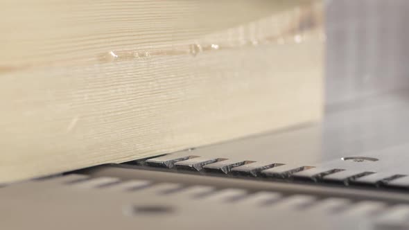 Slow Motion Shot of a Trimming a Board Using a Thickness Planer