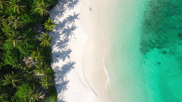 Aerial video beautiful closeup shot beach and seawater on crystal water wave on sand in sunset time