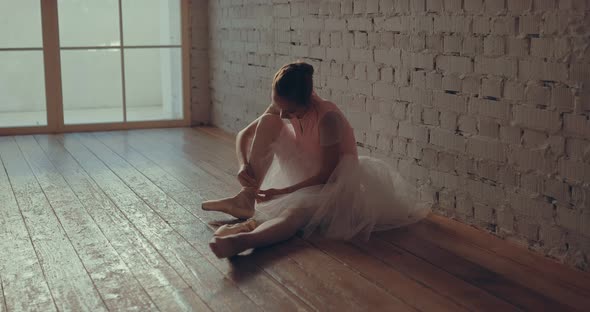 Young Dancer Preparing for the Show Wearing Pointe Shoes