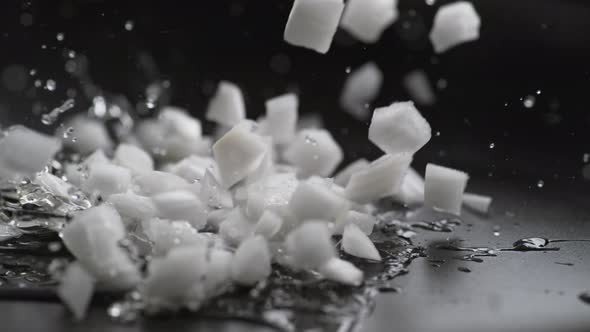 Putting chopped onion on heated non stick fry pan. Slow Motion.