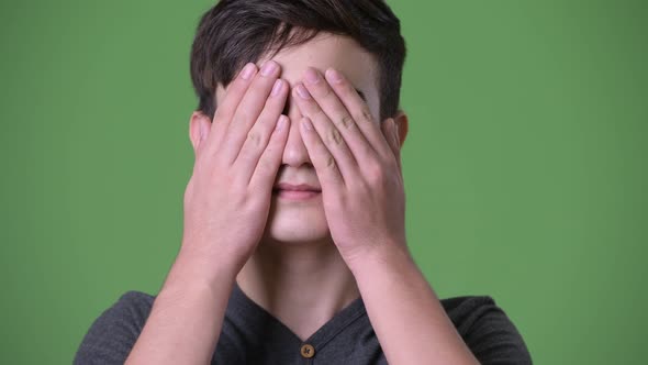 Young Handsome Iranian Teenage Boy Against Green Background