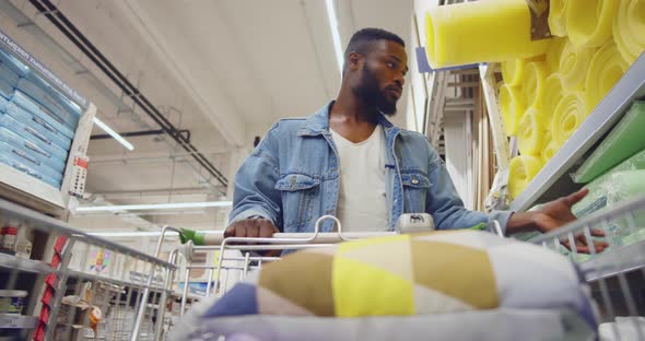 AfricanAmerican Man with Cart Shopping in Houseware Store