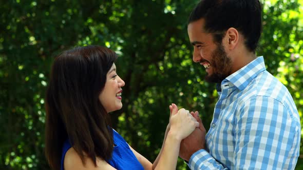 Couple embracing each other in park 