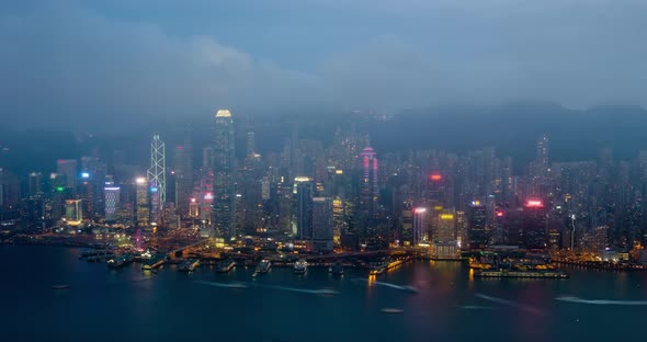 Day To Night Timelapse of Illuminated Hong Kong Skyline. Hong Kong, China