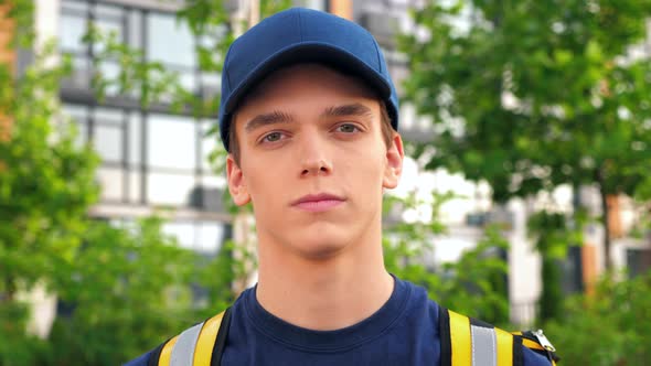 Close Up Delivery Young Man Courier with Thermal Backpack Looking Camera