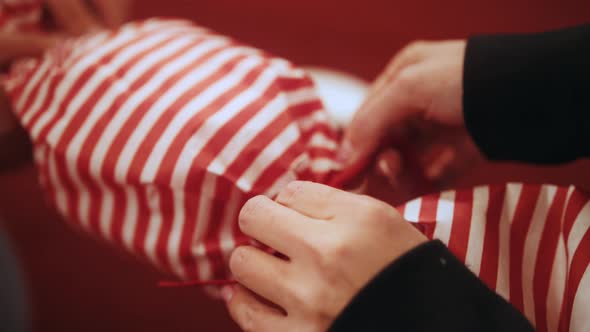 Close Up of Female Hands Making a Big Christmas Decoration in the Form of Candy