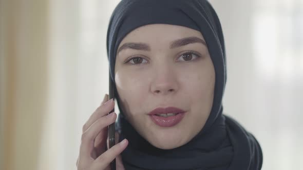 Portrait of a Young Beautiful Eastern Woman in the Modern Muslim Clothes and Beautiful Black