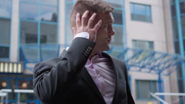 Young Handsome Man in Formal Suit Standing Outdoors Looking Around Waiting for Meeting