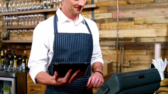 Male waiter working at counter