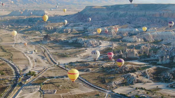 Hot air balloons flying over the valleys of Cappadocia near Goreme, Turkey