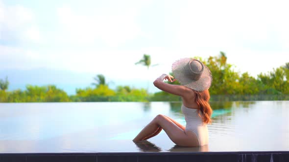 Young asian woman enjoy around outdoor swimming pool for leisure