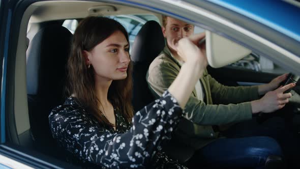 Young Couple is Sitting in the Car