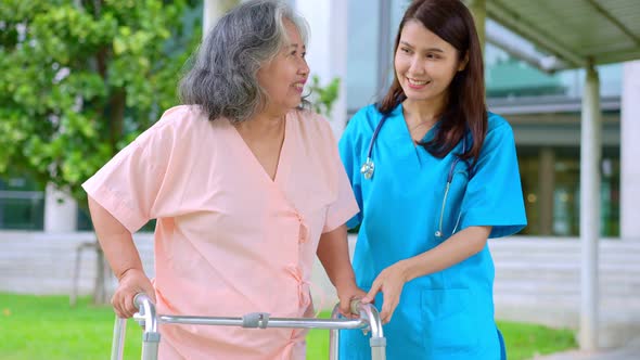 Asian careful caregiver or nurse taking care of the elderly Asian patient in a wheelchair. Concept o