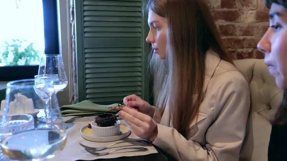 The Girl Tries the Sea Urchin in the Restaurant