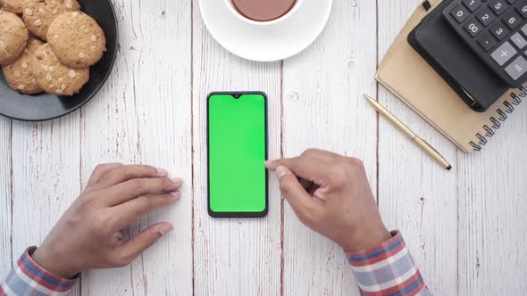 Top View of Man Hand Using Smart Phone on Office Desk