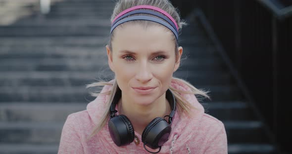 Portrait of smiling woman after hard jogging training 