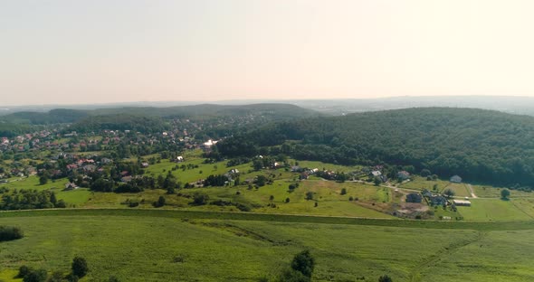 Aerial View of Landscape and Small City Agains Mountains