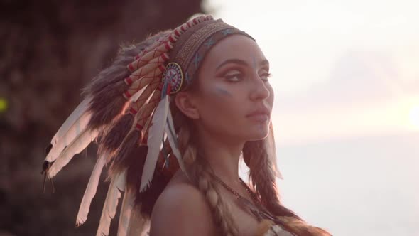 Cinematic Portrait of an American Indian Woman with Painted Makeup and Indian Culture Feather