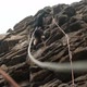 A Male Climber Insures a Rope Climbing a Rocky Route in the Rain - VideoHive Item for Sale