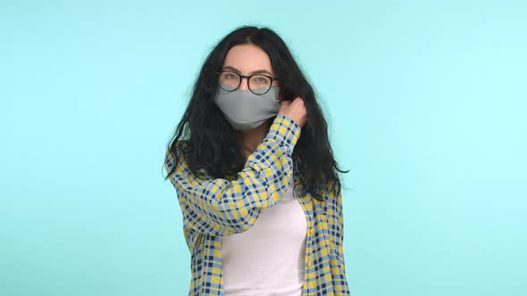 Young Woman Takes Off Face Mask