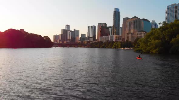 Flyby of a Kayaker Paddling towards Downtown Austin Texas. Shot at golden hour, august 2020