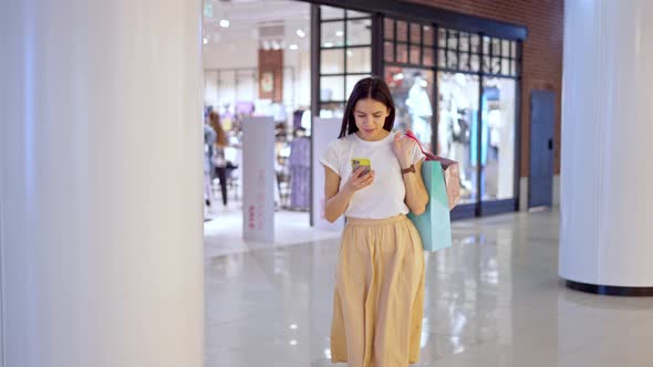 Beautiful Woman Using Online Navigation While Trying to Find Store in Mall