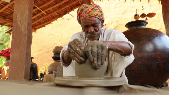 Potter at Work Makes Ceramic Dishes