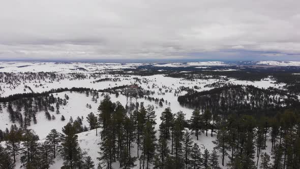 Wilderness Firetower on top of a mountain in the snow Aerial