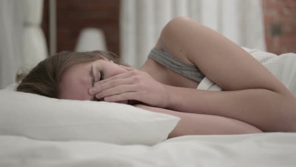 Unhappy Young Woman Crying in Bed