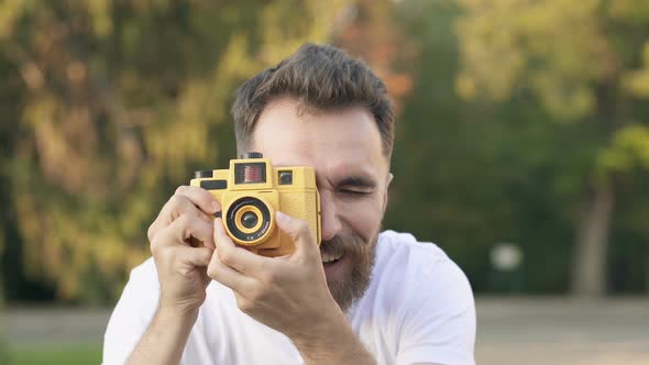 Handsome Bearded Man Taking Pictures on The Photo Camera