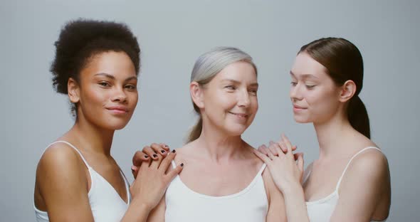 Caucasian Models with Large Age Differences Stand Beside AfricanAmerican Woman