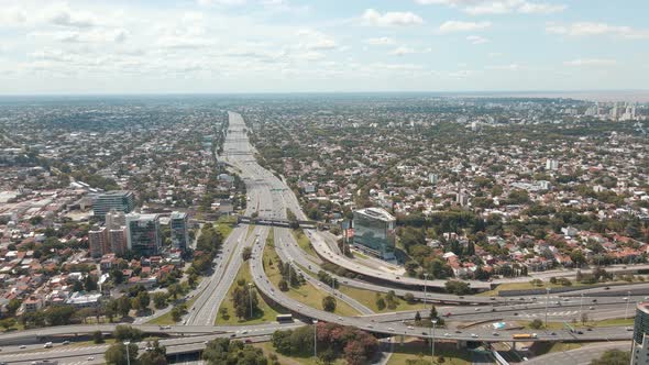 Aerial panning shot revealing Panamericana highway and General Paz avenue interchange