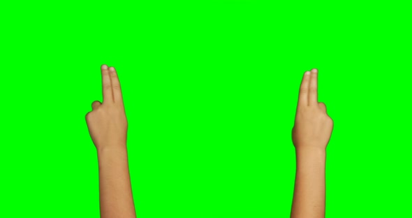 Person making hand gesture against green screen background