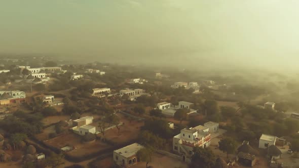 Aerial View Over Misty Local Town In Tharparkar. Follow Shot