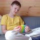 Teenage boy playing with anti-stress rainbow pop it fidget toy. - VideoHive Item for Sale