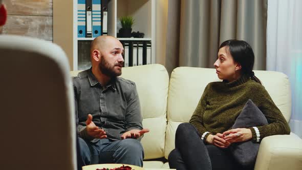 Young Man Telling His Wife in Front of Therapist