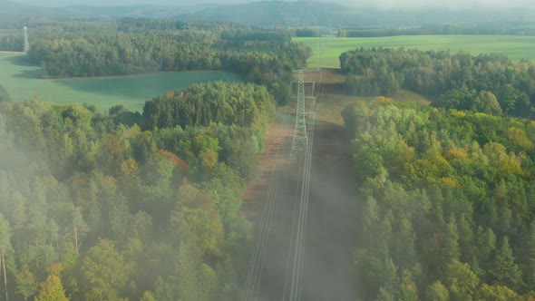 Flight Along High Voltage Power Lines and High Voltage Electric Transmission Tower or Pylon on the