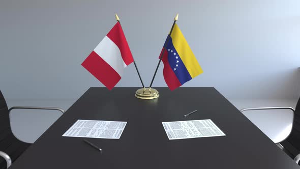 Flags of Peru and Venezuela on the Table
