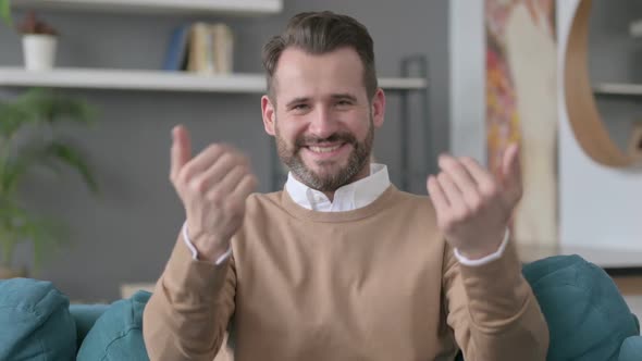 Portrait of Man Pointing Towards Camera and Inviting